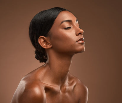 Woman with glowing skin and tilted head in profile — marine collagen and multivitamin support tired, dull skin