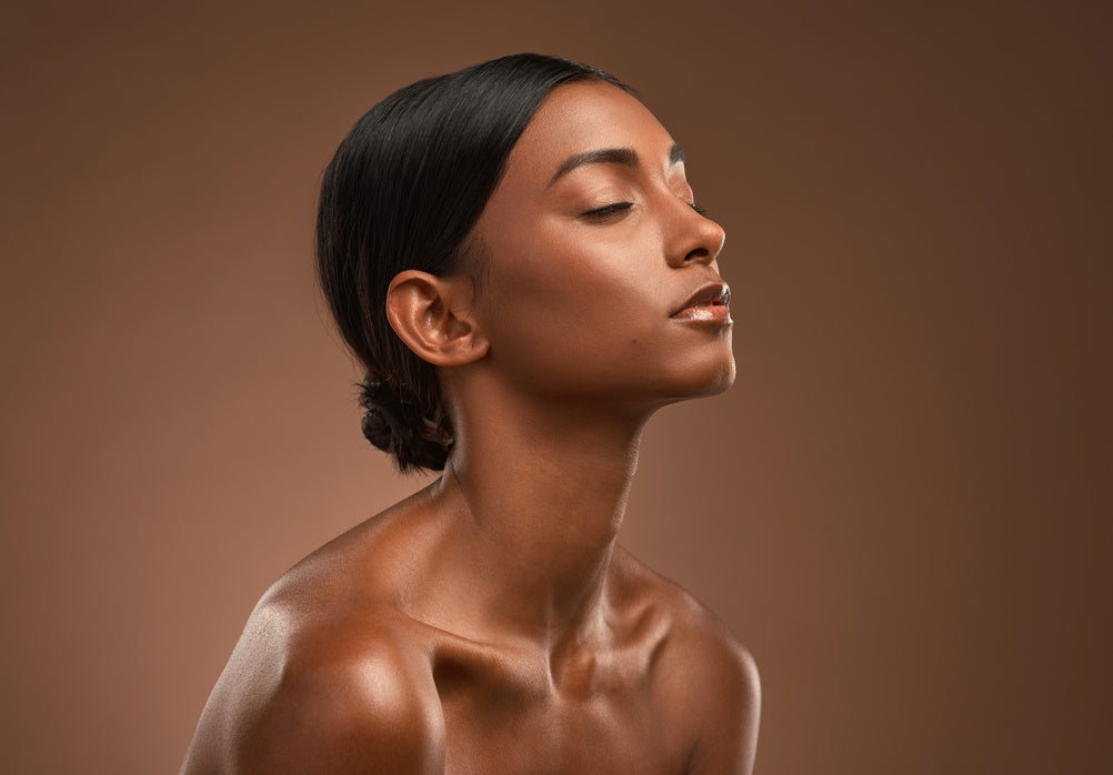 Woman with glowing skin and tilted head in profile — marine collagen and multivitamin support tired, dull skin