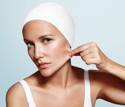 Woman pinching cheek skin to check elasticity — marine collagen supports skin firmness, elasticity and ageing