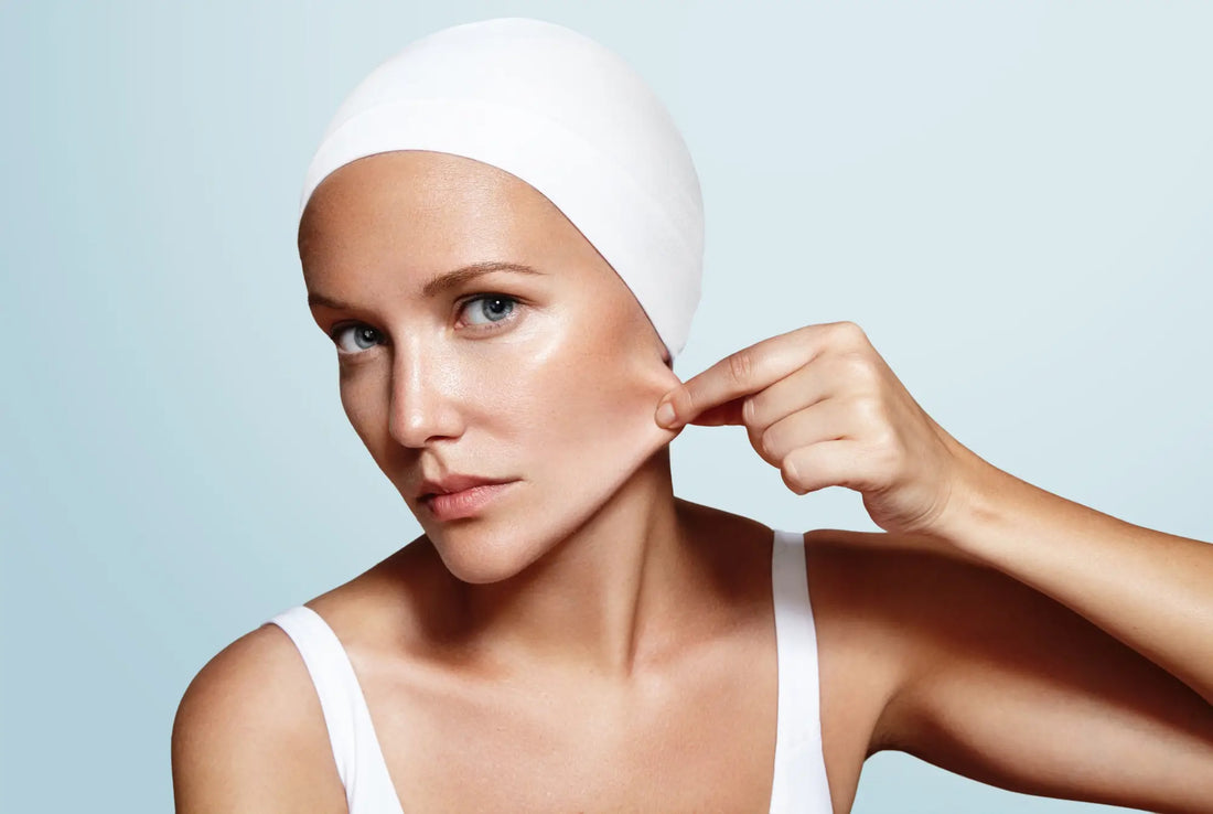 Woman pinching cheek skin to check elasticity — marine collagen supports skin firmness, elasticity and ageing