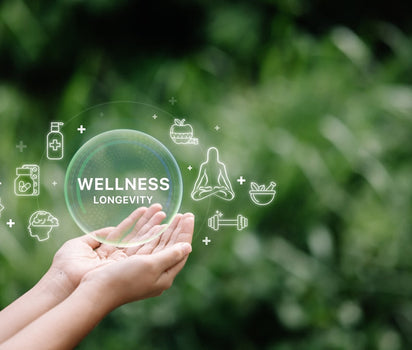 Hands holding wellness icons — daily multivitamin and probiotic support overall health and longevity