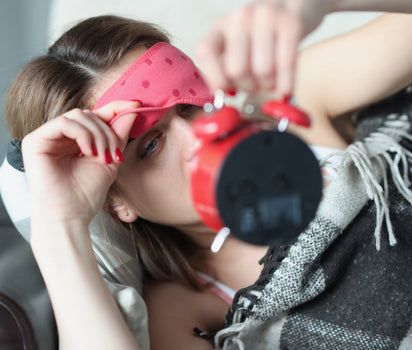 Magnesium supports better sleep — woman lifting sleep mask to check alarm clock at 3am