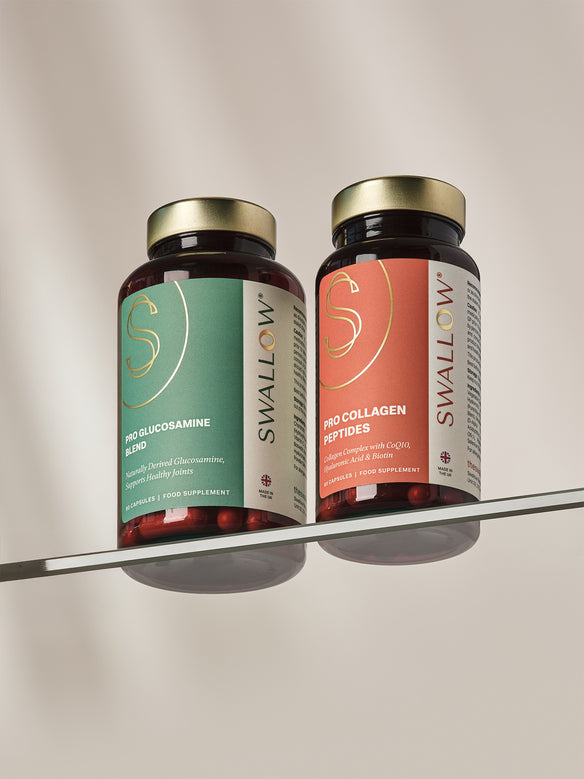 Two Swallow brand supplement bottles on a glass shelf with a neutral background
