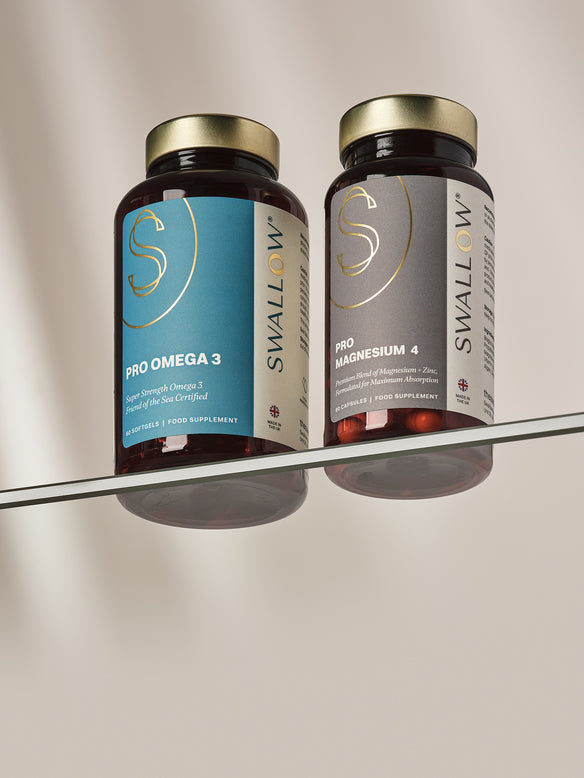 Two Swallow brand supplement bottles on a reflective surface with a neutral background